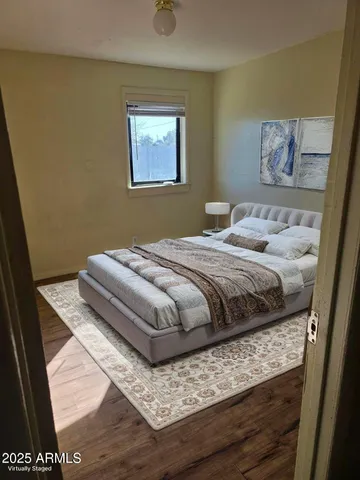 a bedroom with a bed and wall painting