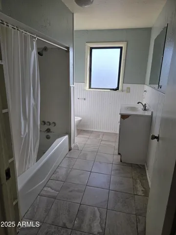 a bathroom with a shower and a sink