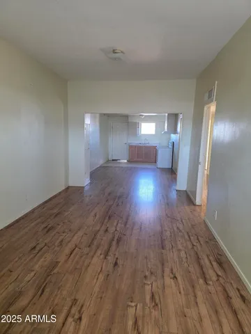 a view of a room with wooden floor