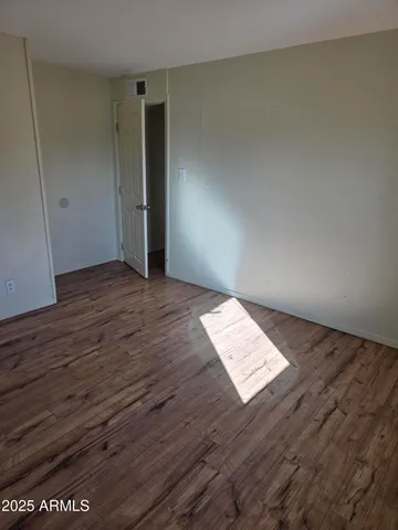 a view of wooden floor and windows in a room