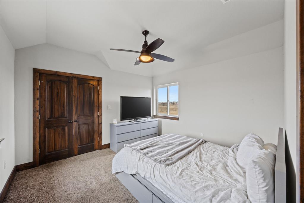 13688 Jackson Road Ponder, TX 76259 - Photo 13 of 20 a bedroom with a bed and a flat tv screen on the dresser