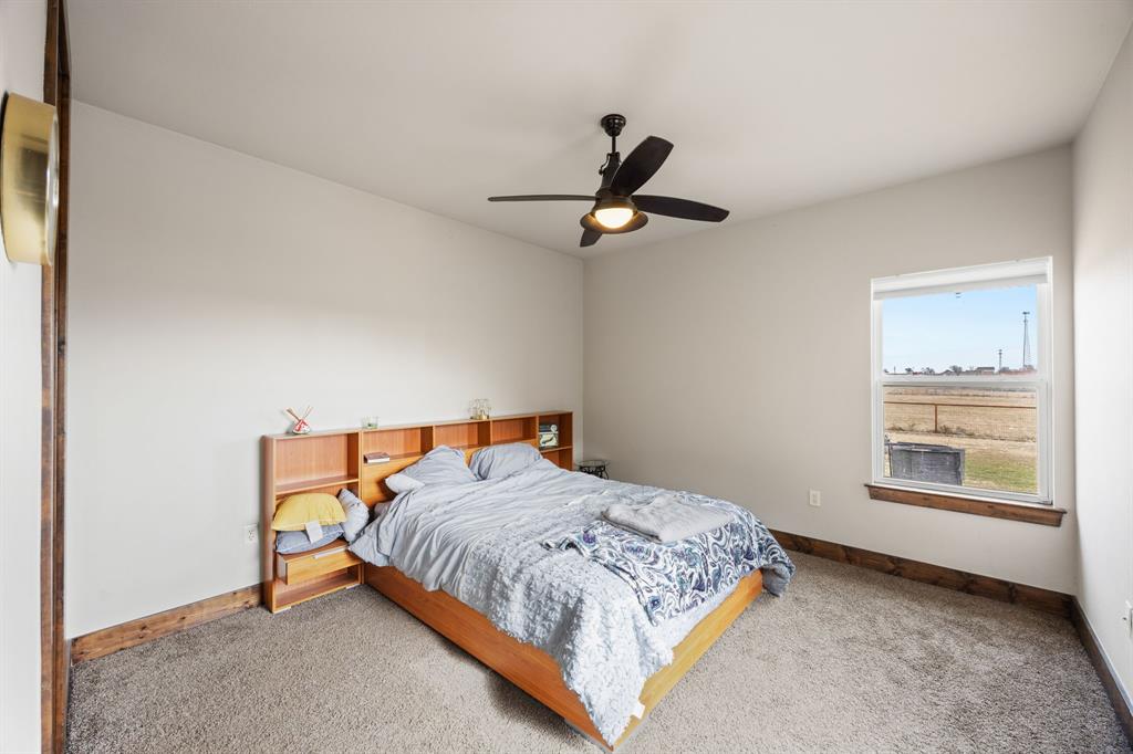 13688 Jackson Road Ponder, TX 76259 - Photo 15 of 20 a bedroom with a bed a dresser and a window