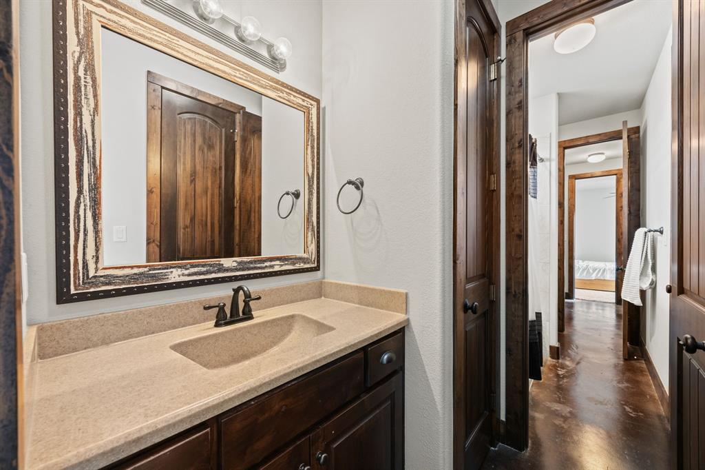 13688 Jackson Road Ponder, TX 76259 - Photo 16 of 20 a bathroom with a granite countertop sink and a mirror