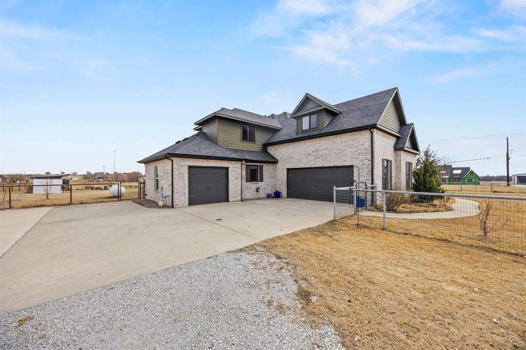 13688 Jackson Road Ponder, TX 76259 - Photo 19 of 20 a front view of a house with a yard and garage
