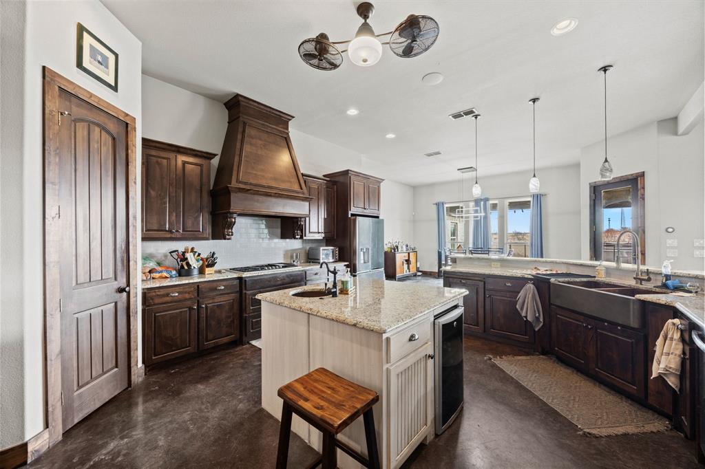 13688 Jackson Road Ponder, TX 76259 - Photo 8 of 20 a kitchen with stainless steel appliances granite countertop a sink stove and refrigerator