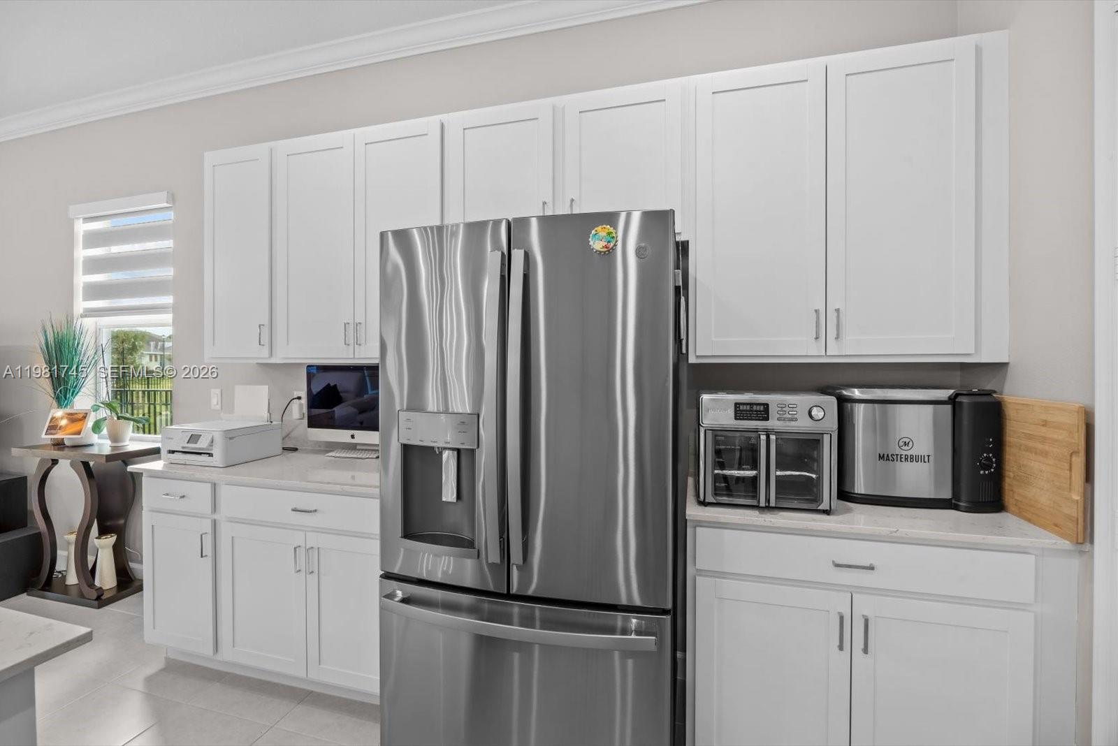1204 Southeast Woodbine Road Port St. Lucie, FL 34984 - Photo 12 of 46 a kitchen with appliances cabinets and a window