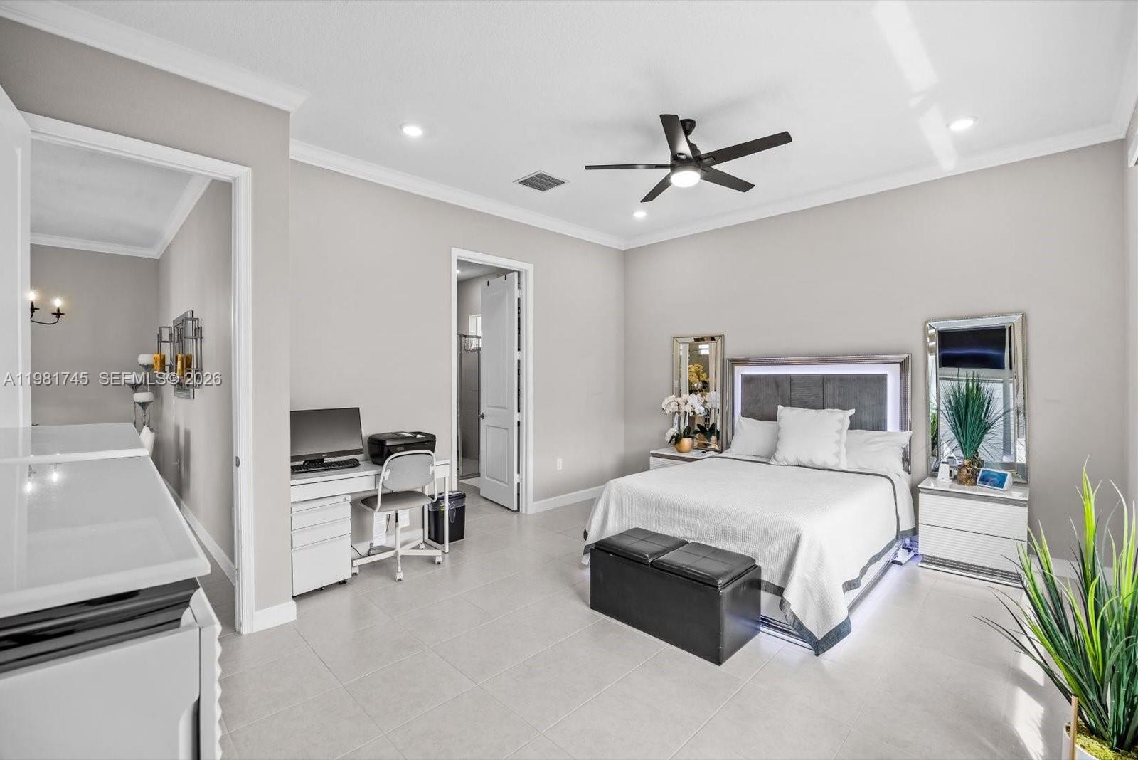 1204 Southeast Woodbine Road Port St. Lucie, FL 34984 - Photo 21 of 46 a bedroom with a bed and a chandelier