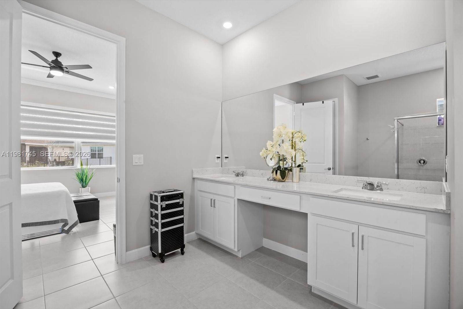 1204 Southeast Woodbine Road Port St. Lucie, FL 34984 - Photo 24 of 46 a spacious bathroom with a double vanity sink a mirror and a bathtub