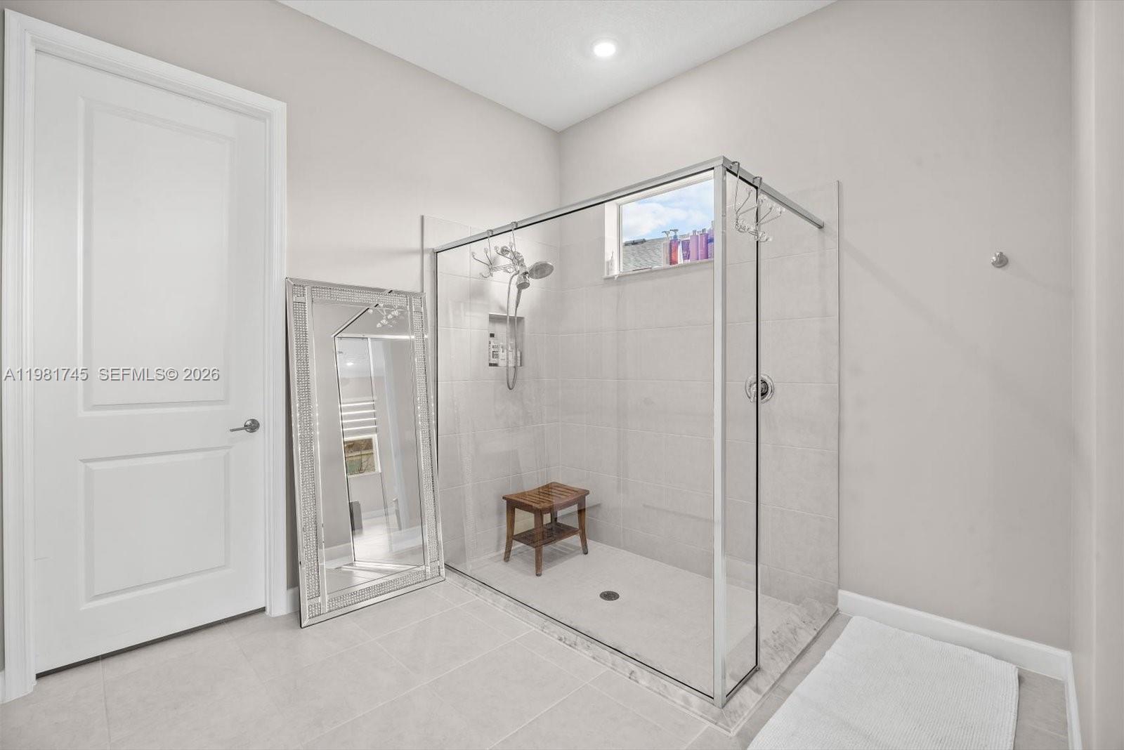 1204 Southeast Woodbine Road Port St. Lucie, FL 34984 - Photo 25 of 46 a bathroom with a shower and a glass door
