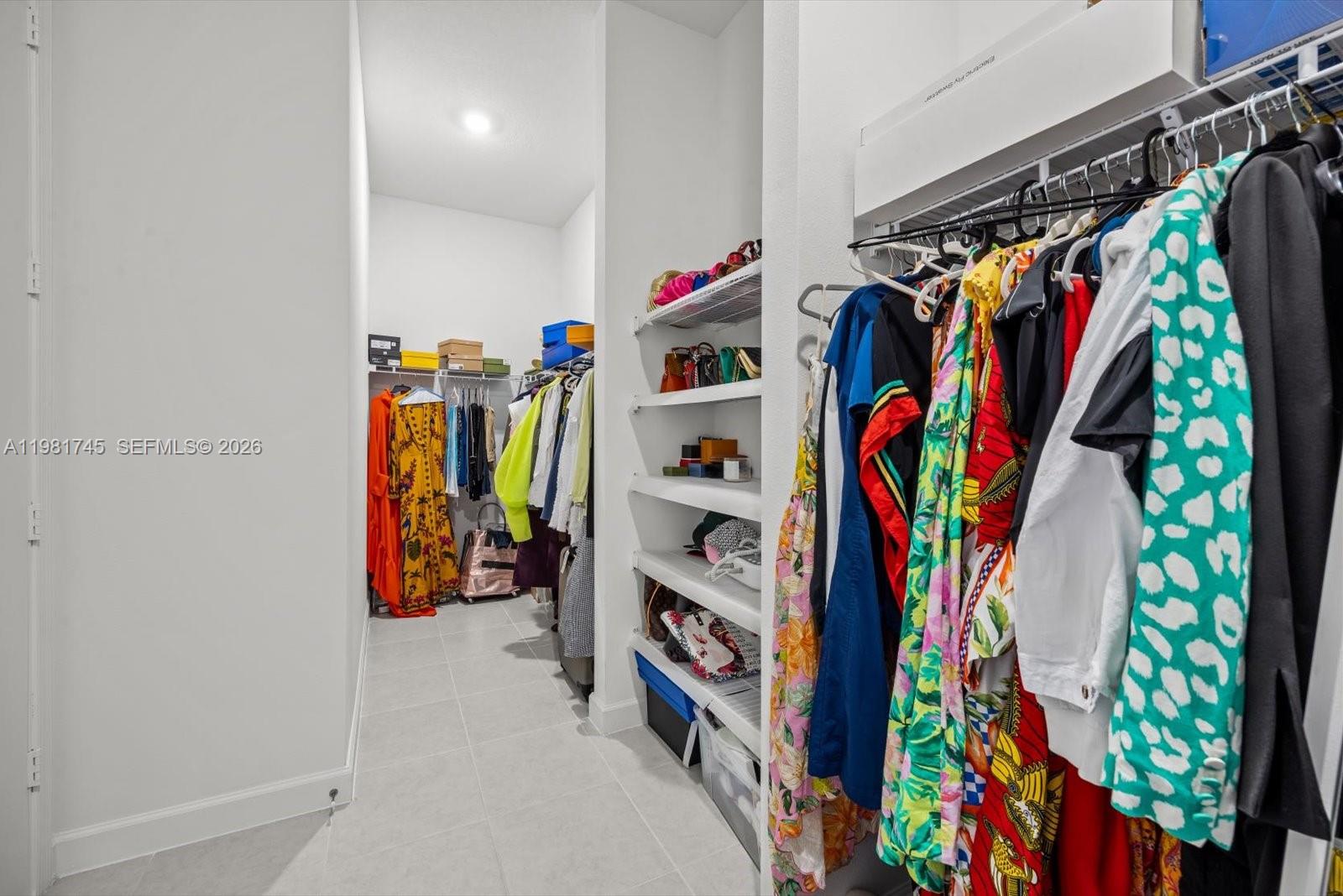 1204 Southeast Woodbine Road Port St. Lucie, FL 34984 - Photo 26 of 46 a view of walk in closet with clothes and shoes