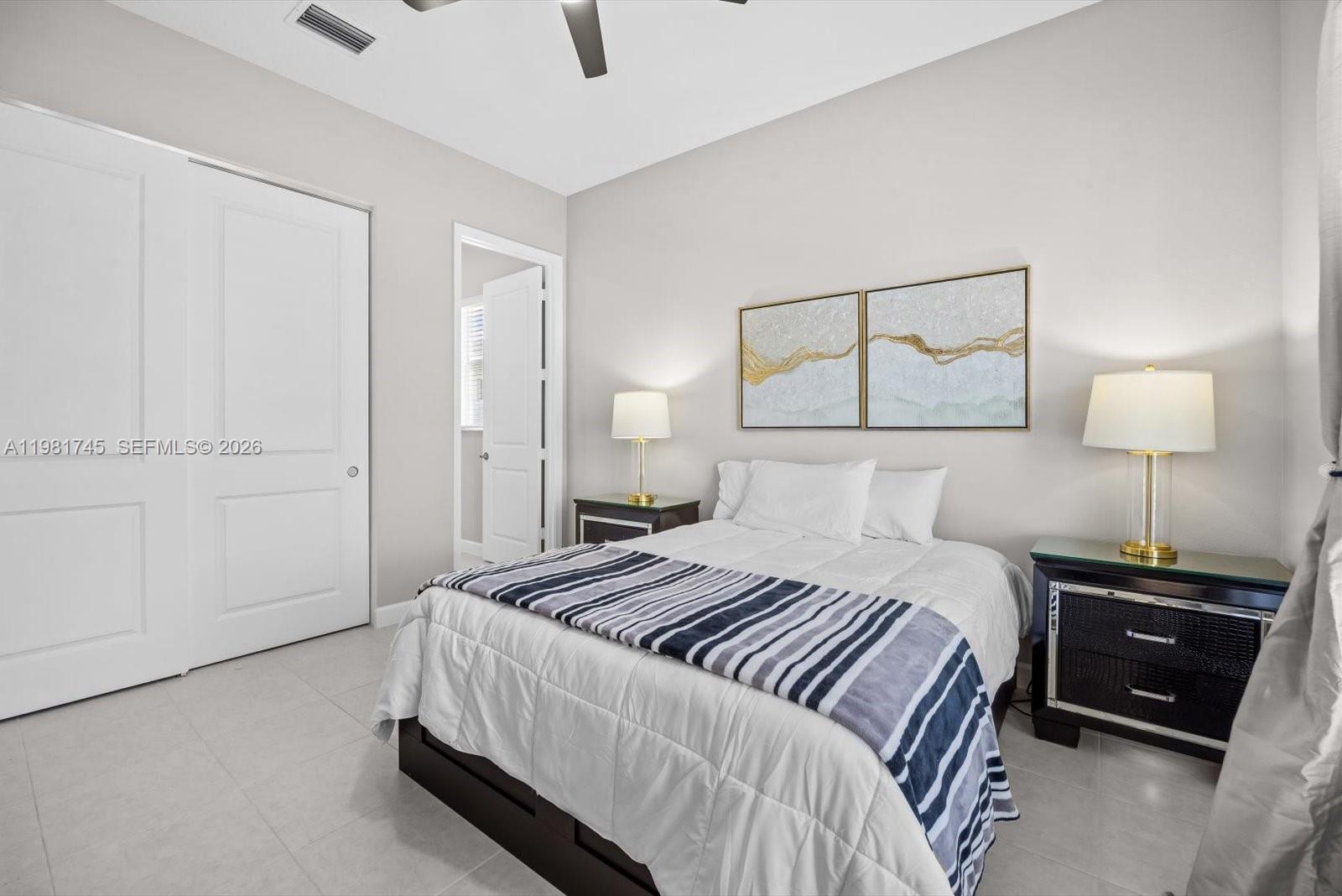 1204 Southeast Woodbine Road Port St. Lucie, FL 34984 - Photo 29 of 46 a bedroom with a bed and a night stand