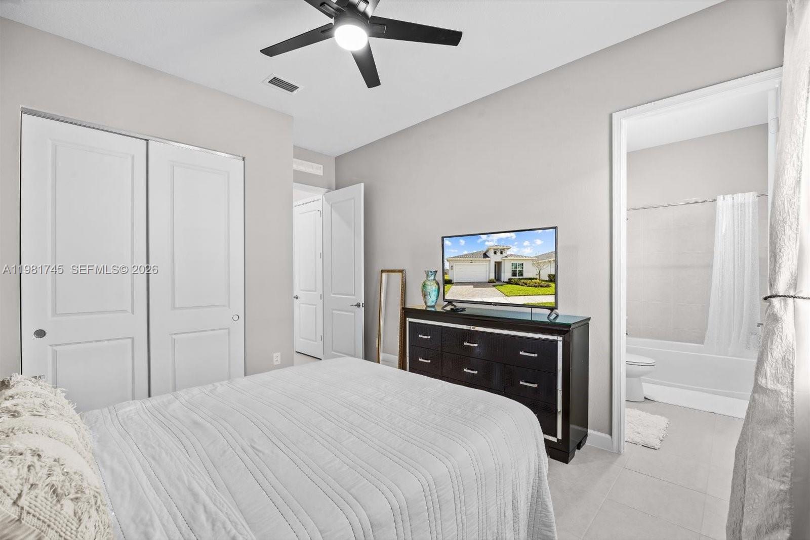 1204 Southeast Woodbine Road Port St. Lucie, FL 34984 - Photo 33 of 46 a bedroom with a bed and a dresser