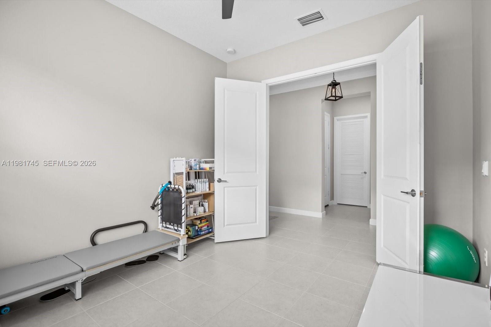 1204 Southeast Woodbine Road Port St. Lucie, FL 34984 - Photo 36 of 46 a view of a room with gym equipment