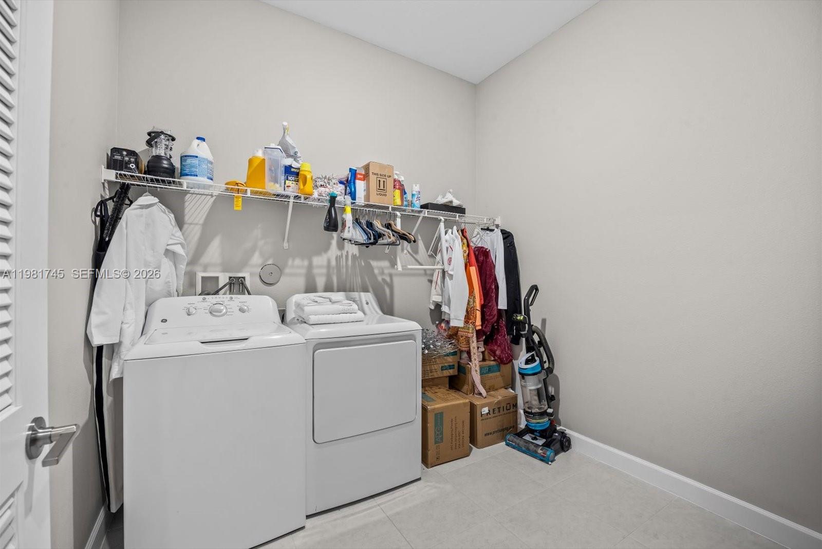 1204 Southeast Woodbine Road Port St. Lucie, FL 34984 - Photo 38 of 46 a utility room with dryer and washer