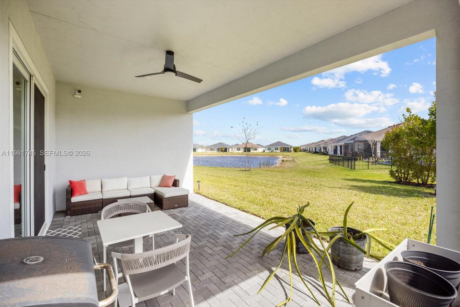 1204 Southeast Woodbine Road Port St. Lucie, FL 34984 - Photo 39 of 46 a living room with furniture and floor to ceiling window