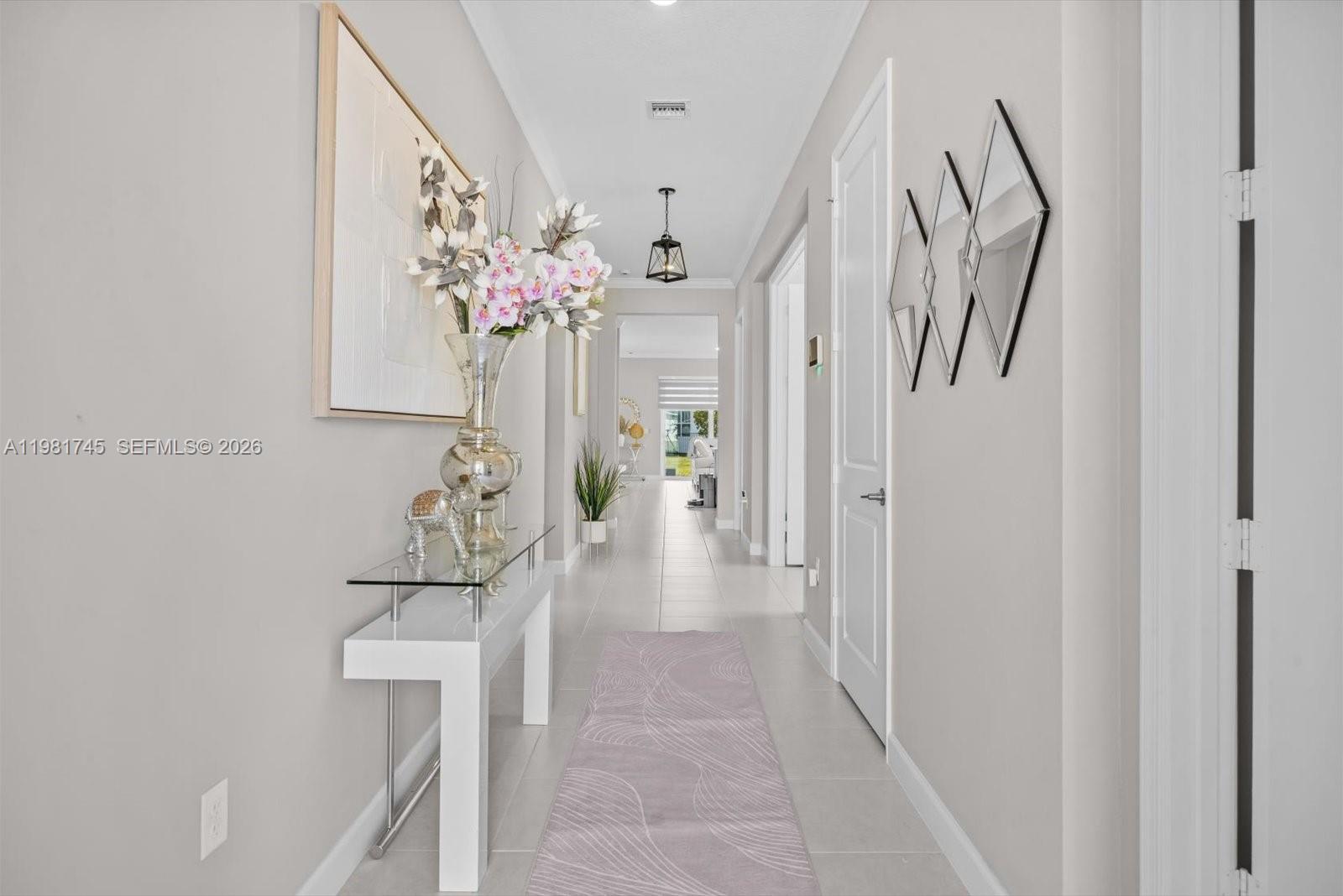 1204 Southeast Woodbine Road Port St. Lucie, FL 34984 - Photo 4 of 46 a view of a hallway with a flower pot