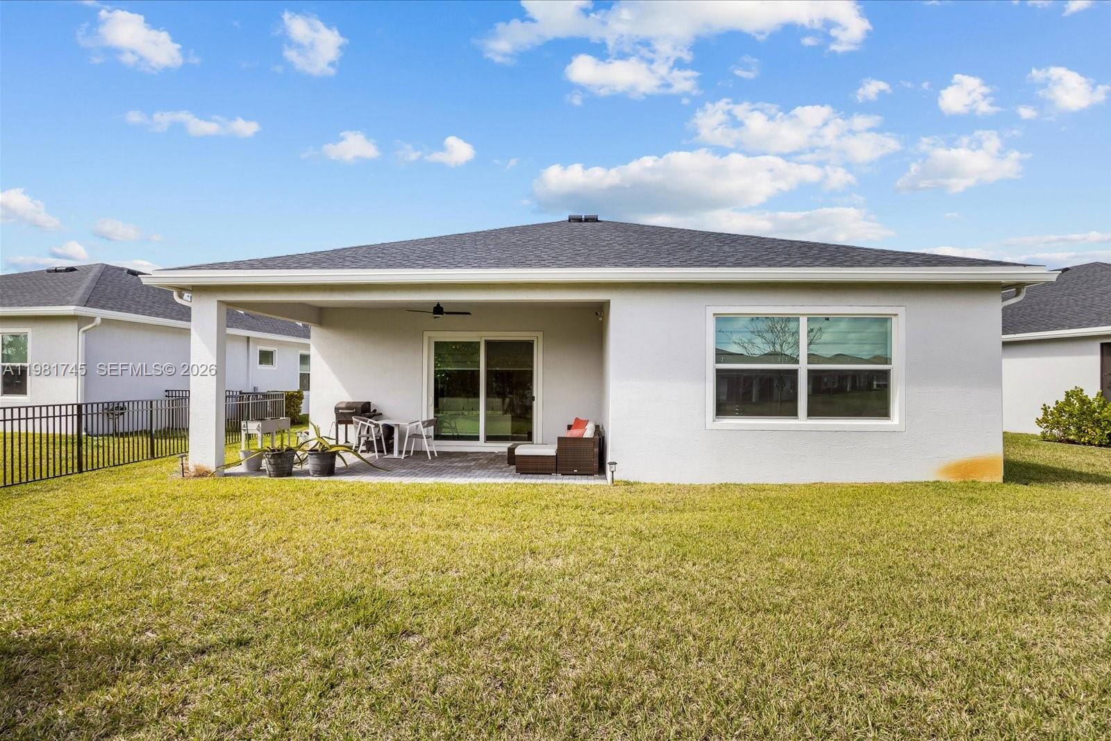 1204 Southeast Woodbine Road Port St. Lucie, FL 34984 - Photo 42 of 46 a view of a house with swimming pool and porch with furniture