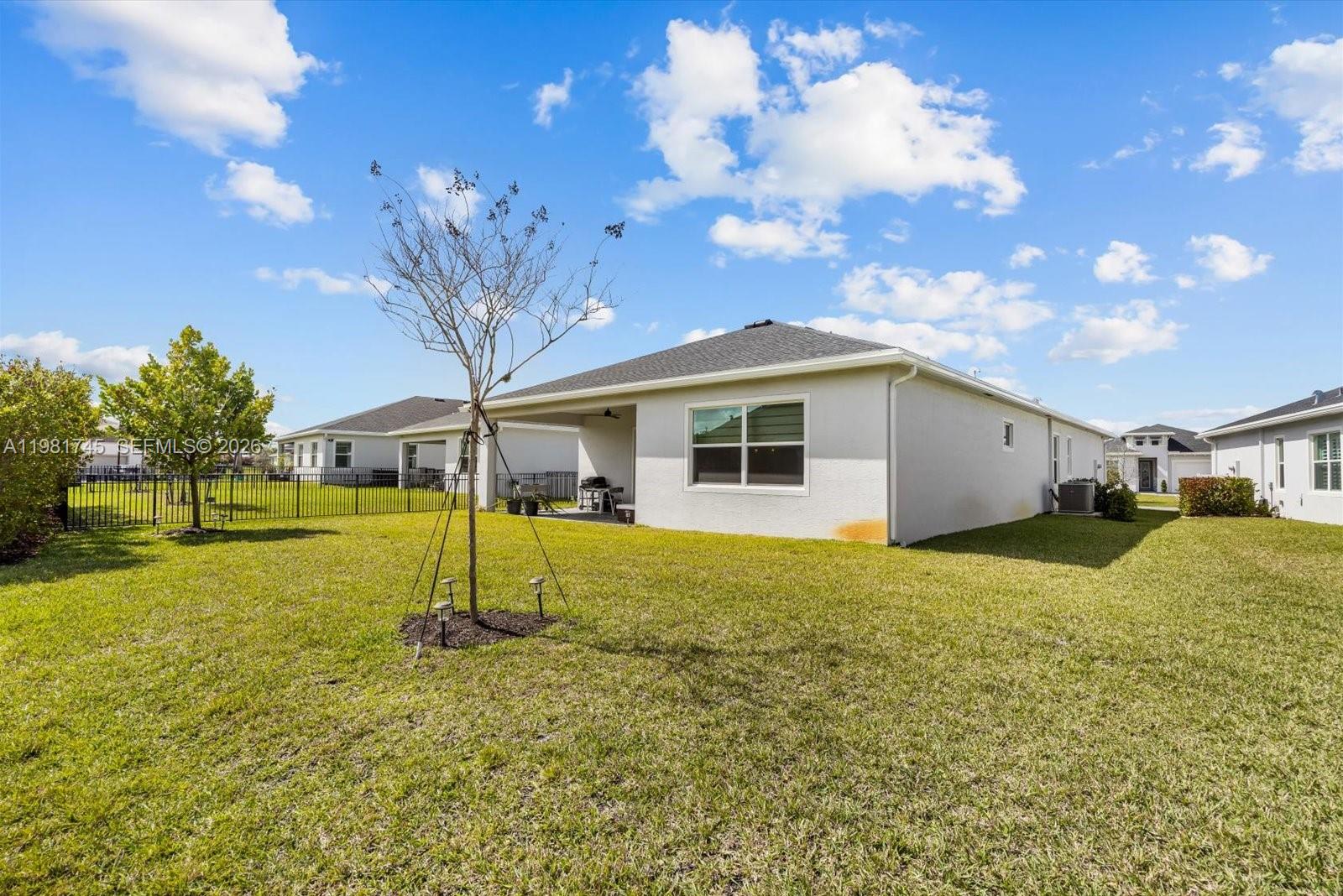 1204 Southeast Woodbine Road Port St. Lucie, FL 34984 - Photo 43 of 46 a house view with swimming pool in front of it