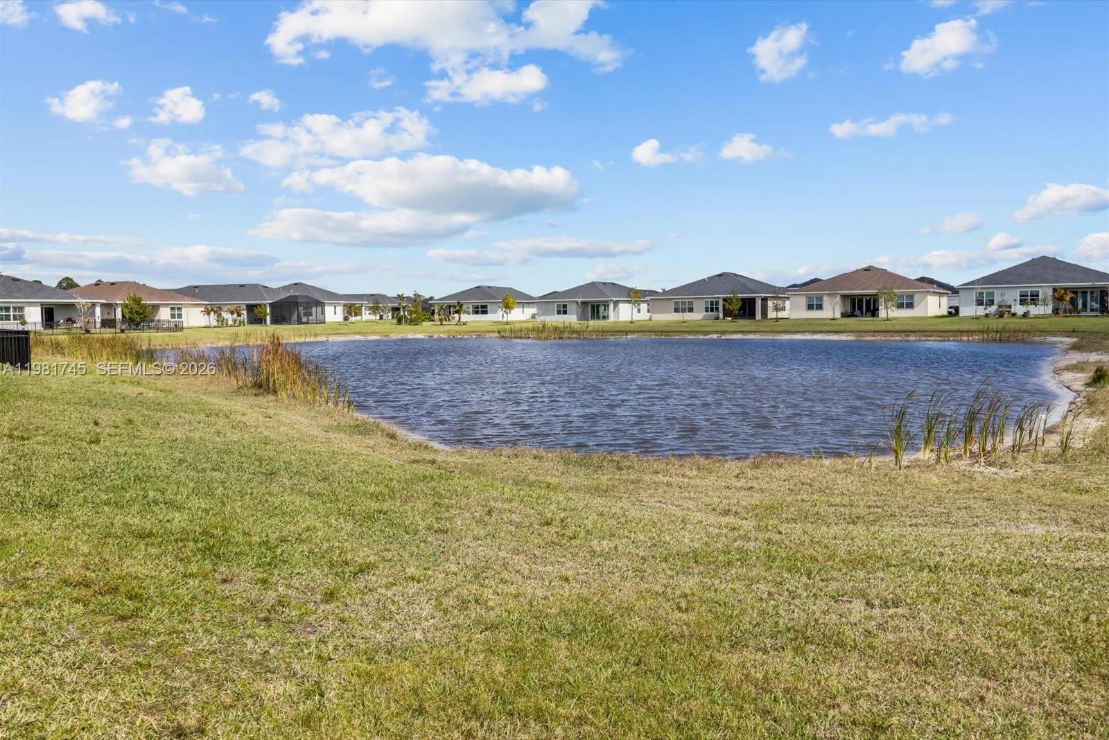 1204 Southeast Woodbine Road Port St. Lucie, FL 34984 - Photo 45 of 46 a view of an ocean with a mountain