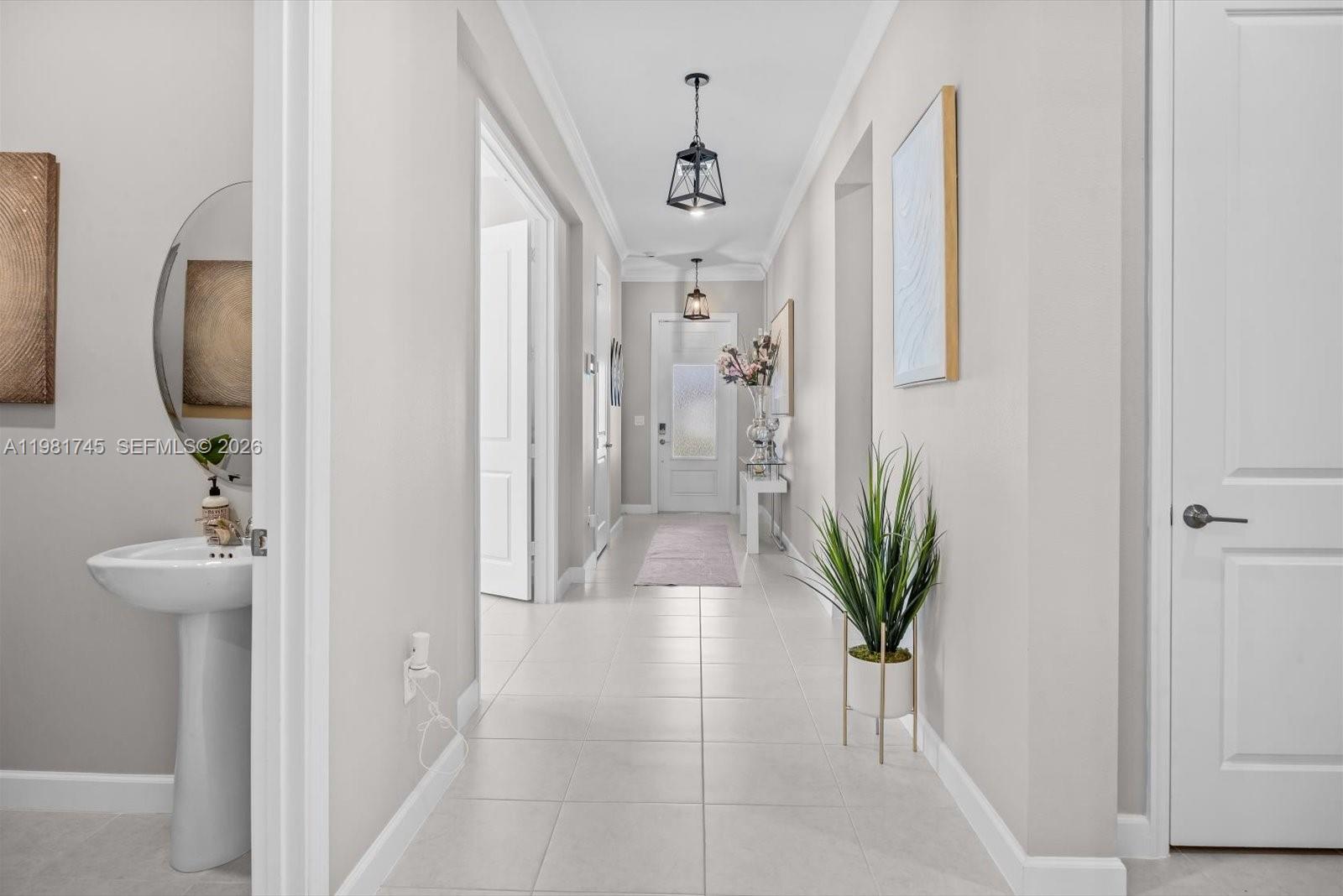1204 Southeast Woodbine Road Port St. Lucie, FL 34984 - Photo 5 of 46 a view of a hallway with paintings on the wall