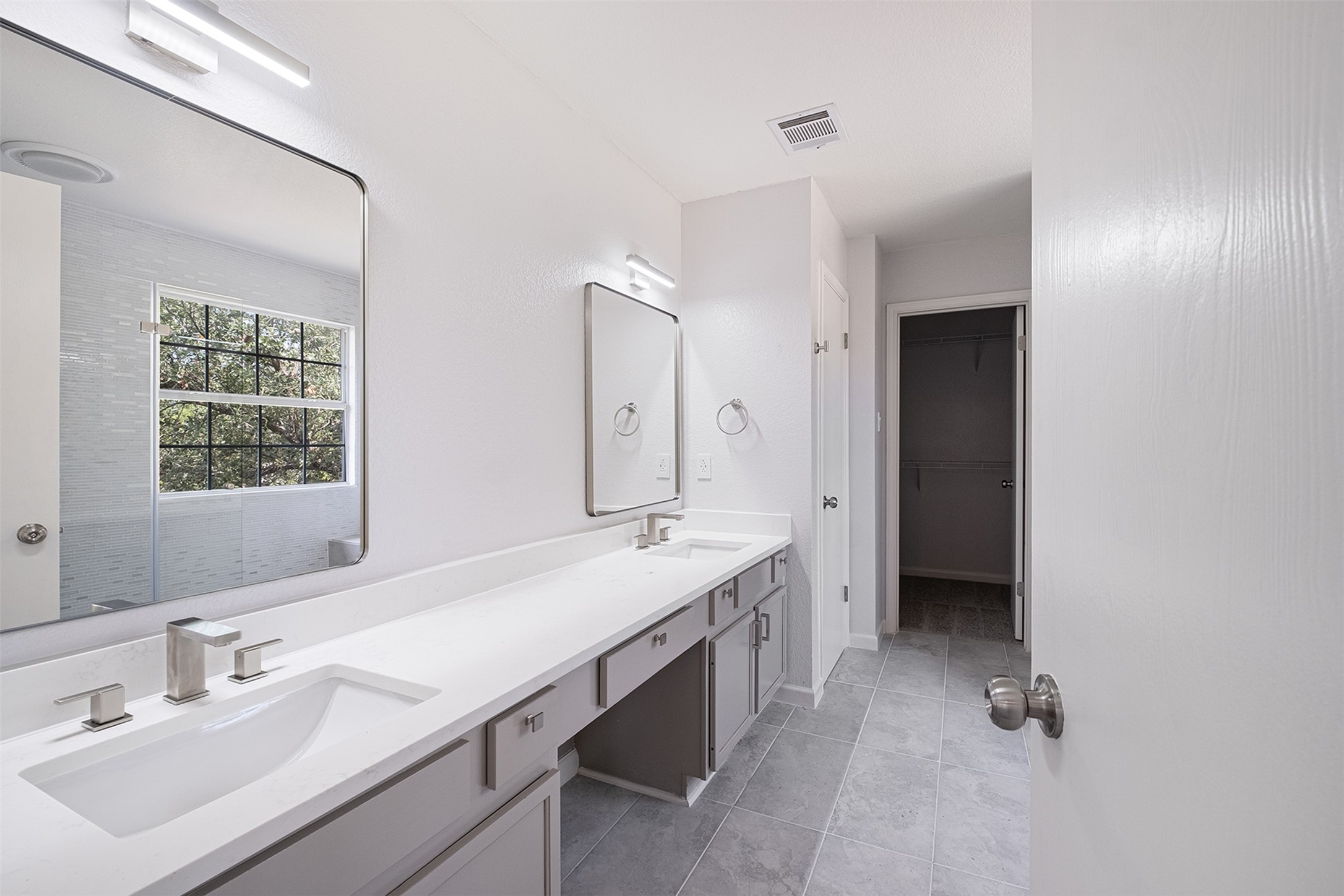 2101 Bridal Path Cedar Park, TX 78613 - Photo 29 of 38 a spacious bathroom with a double vanity sink a mirror and a bathtub