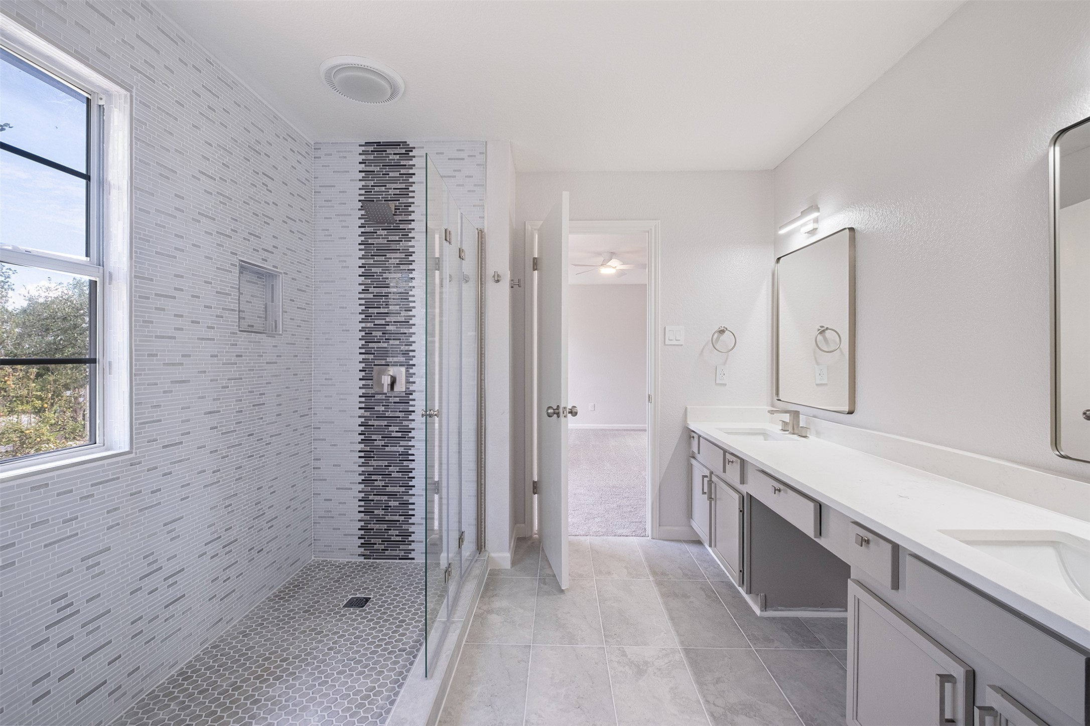 2101 Bridal Path Cedar Park, TX 78613 - Photo 32 of 38 a bathroom with a shower sink and mirror