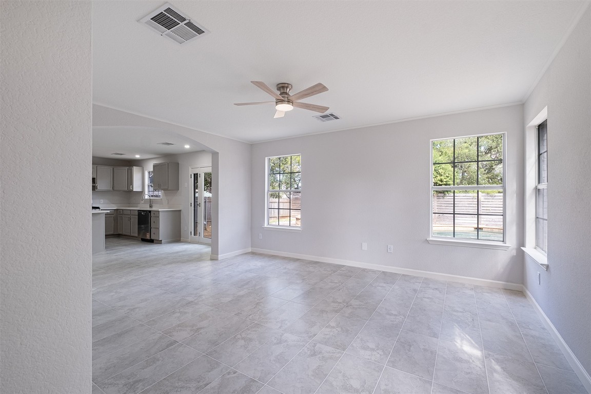 2101 Bridal Path Cedar Park, TX 78613 - Photo 6 of 38 an empty room with windows and chandelier fan