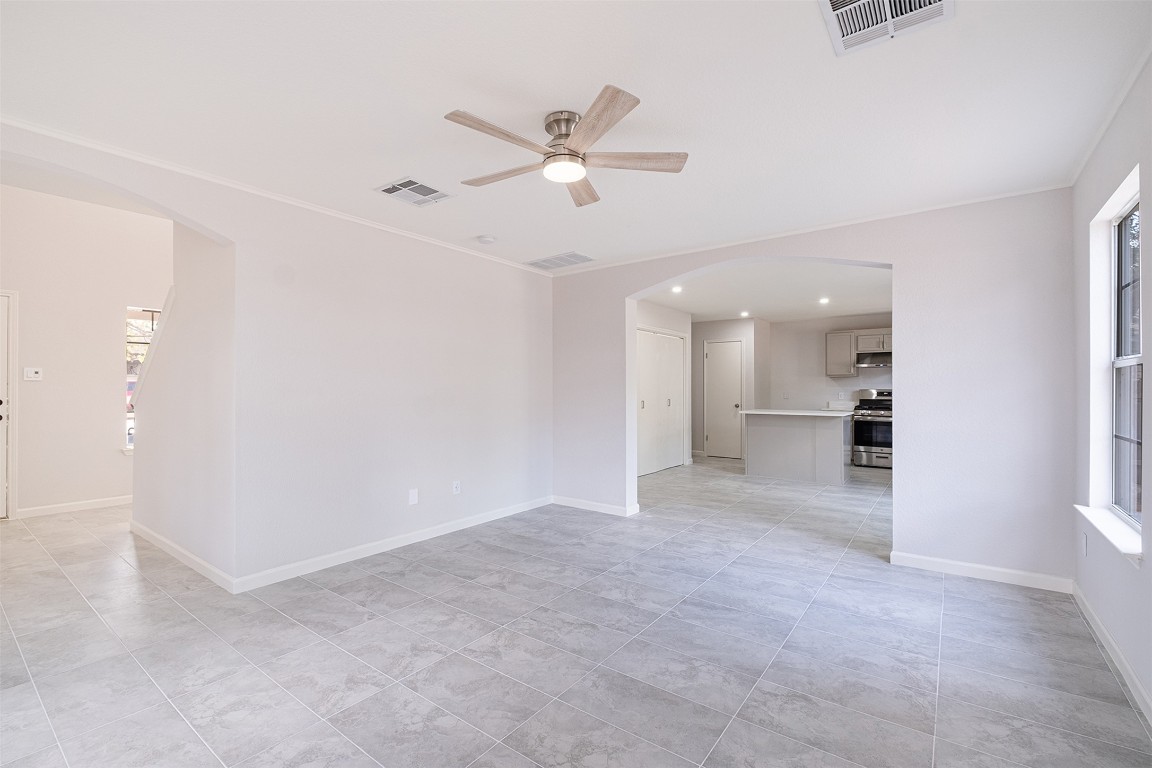 2101 Bridal Path Cedar Park, TX 78613 - Photo 8 of 38 an empty room with a kitchen and a ceiling fan