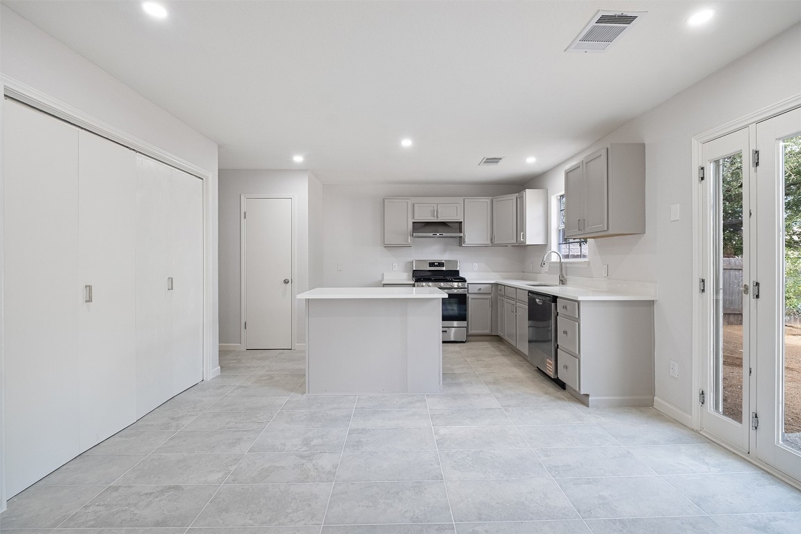 2101 Bridal Path Cedar Park, TX 78613 - Photo 10 of 38 a kitchen with a refrigerator and a stove top oven