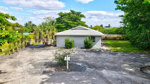 a view of a house with a yard and tree s
