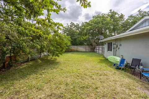 a view of a patio with table and chairs potted plants with wooden fence