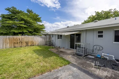a backyard of a house with table and chairs