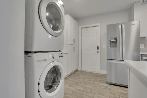 a view of a hallway with washer and dryer