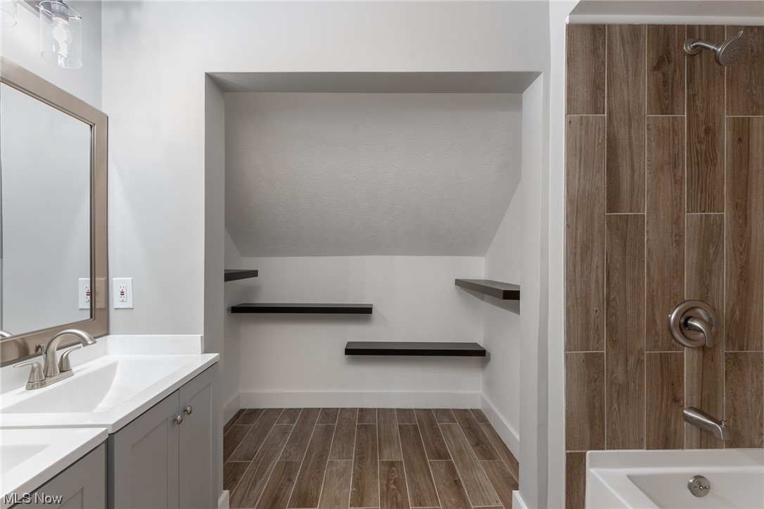 3517 Bainbridge Road Cleveland Heights, OH 44118 - Photo 19 of 35 Bathroom with vanity, lofted ceiling, a textured ceiling, and wood-type flooring