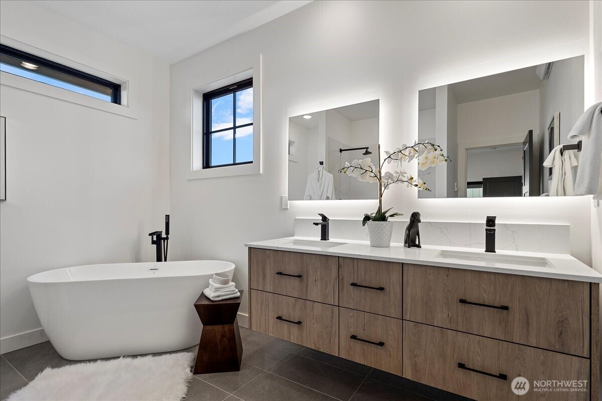 211 Pebblebrook Drive Lynden, WA 98264 - Photo 15 of 36 a bathroom with a double vanity sink mirror and bathtub