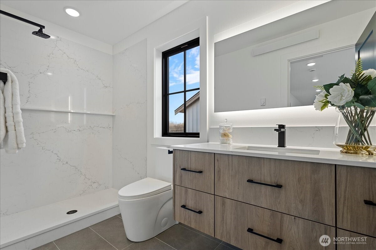 211 Pebblebrook Drive Lynden, WA 98264 - Photo 5 of 36 a bathroom with a sink a toilet and shower