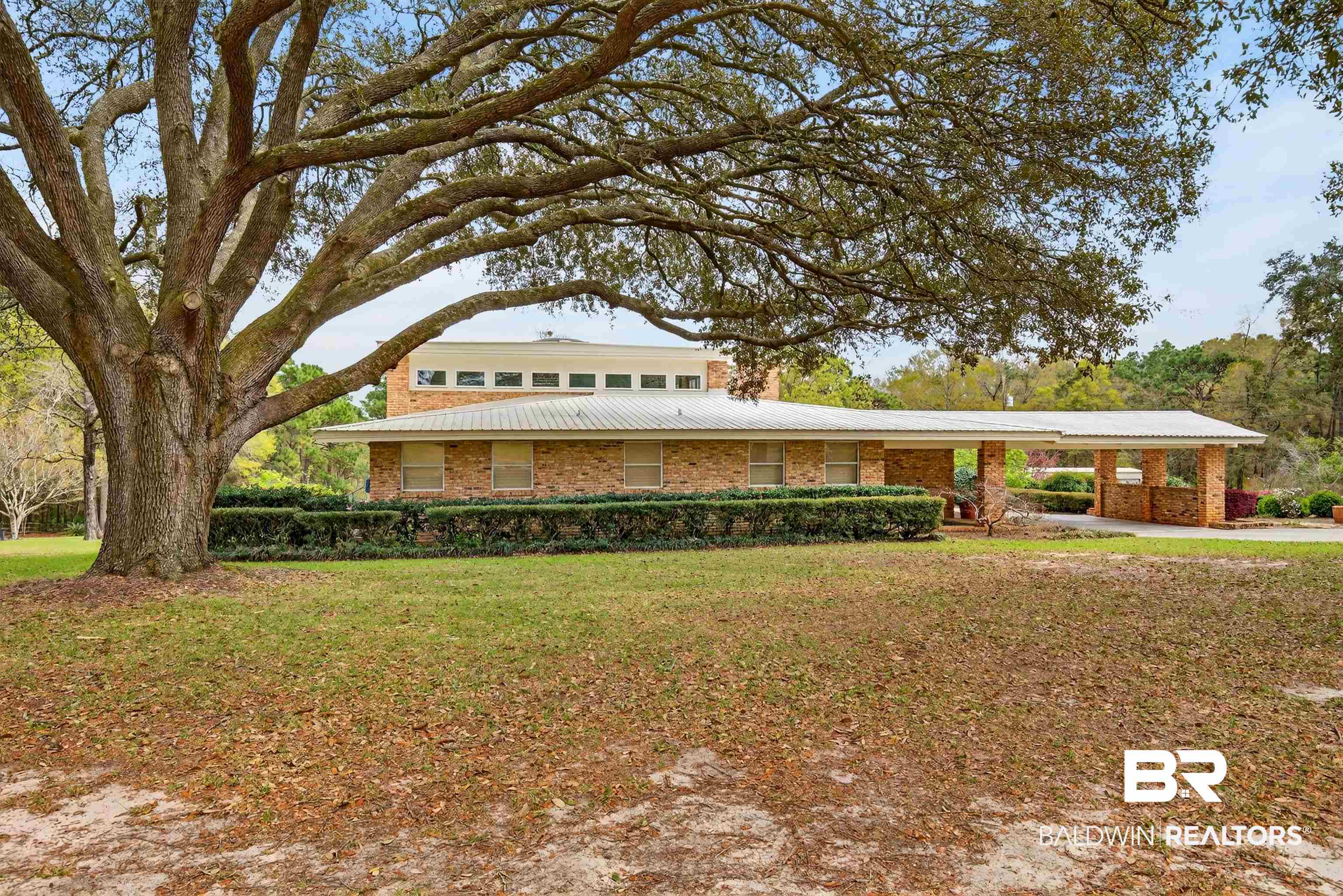 3175 Dawes Lake Road Mobile, AL 36619 - Photo 1 of 92 View of front of property with a metal roof, a front yard, brick siding, and an attached carport