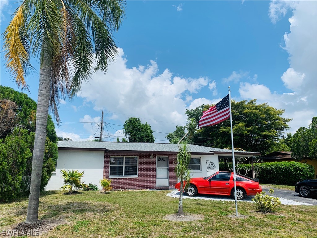 18189 Iris Road Fort Myers, FL 33967 - Photo 1 of 30 a front view of house with yard and trees