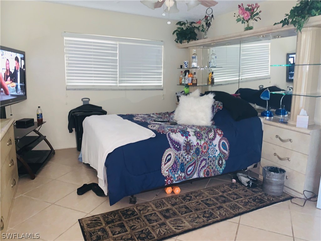 18189 Iris Road Fort Myers, FL 33967 - Photo 13 of 30 a bedroom with a bed and window