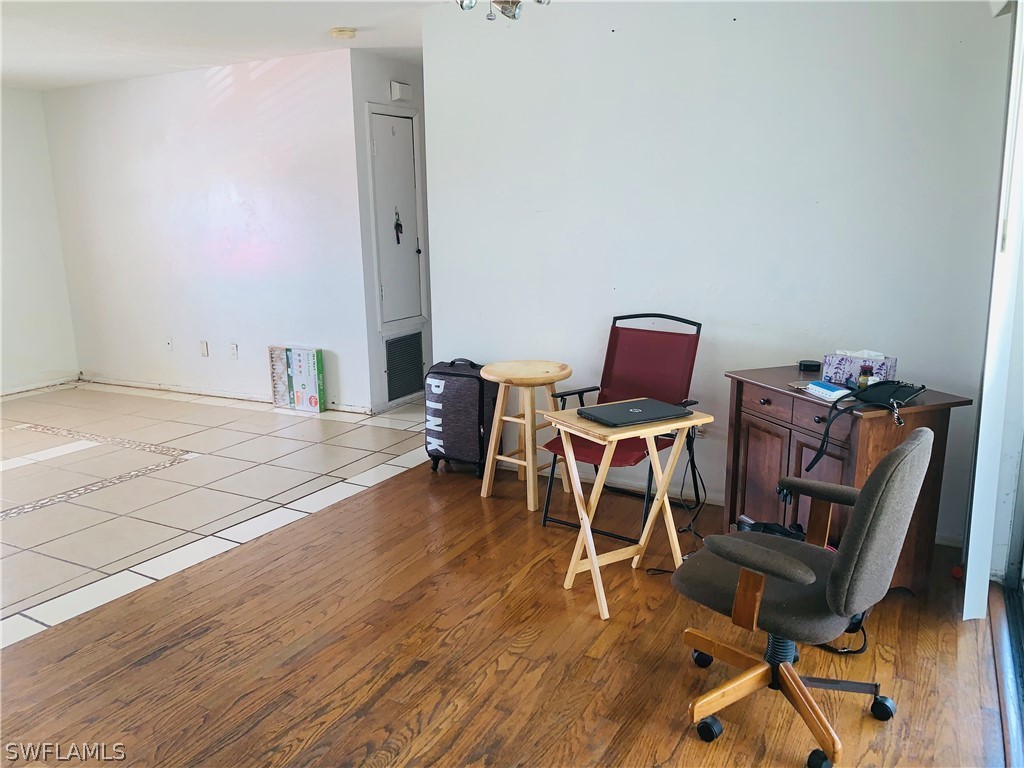 18189 Iris Road Fort Myers, FL 33967 - Photo 21 of 30 a room with furniture and wooden floor