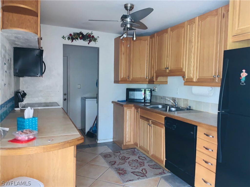 18189 Iris Road Fort Myers, FL 33967 - Photo 4 of 30 a kitchen with stainless steel appliances granite countertop a sink stove and refrigerator