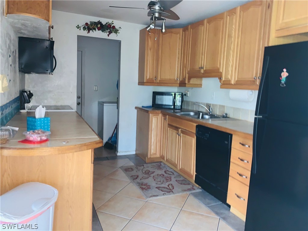 18189 Iris Road Fort Myers, FL 33967 - Photo 5 of 30 a kitchen with a sink a stove and cabinets