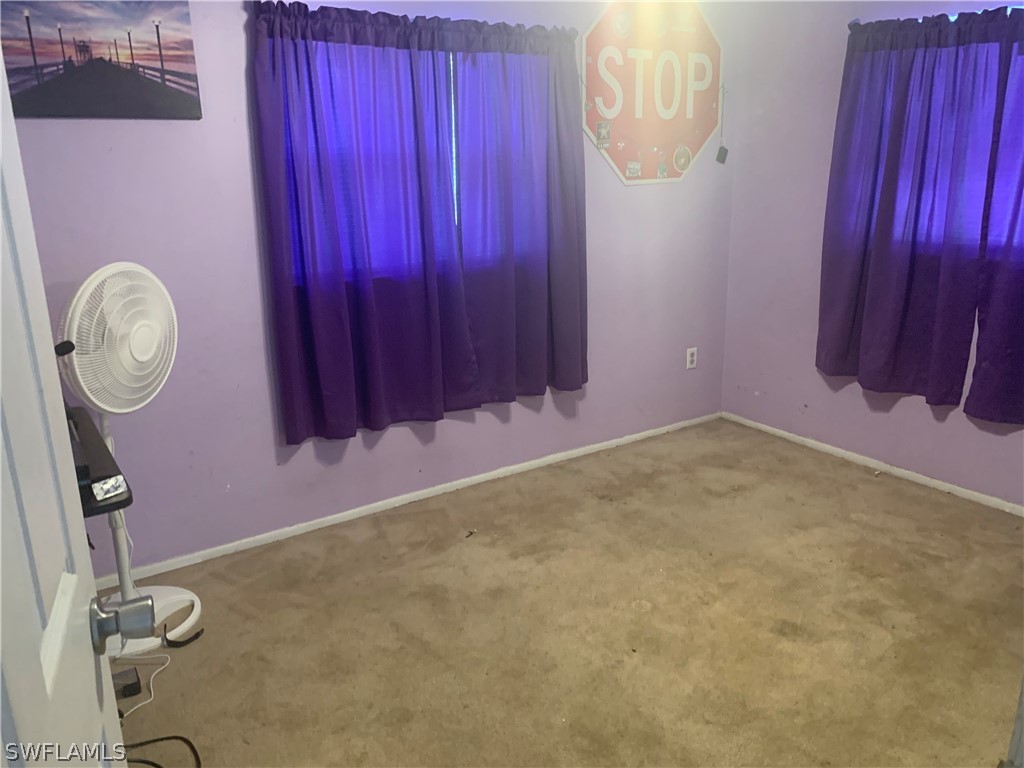 18189 Iris Road Fort Myers, FL 33967 - Photo 8 of 30 a room with a table and a chair