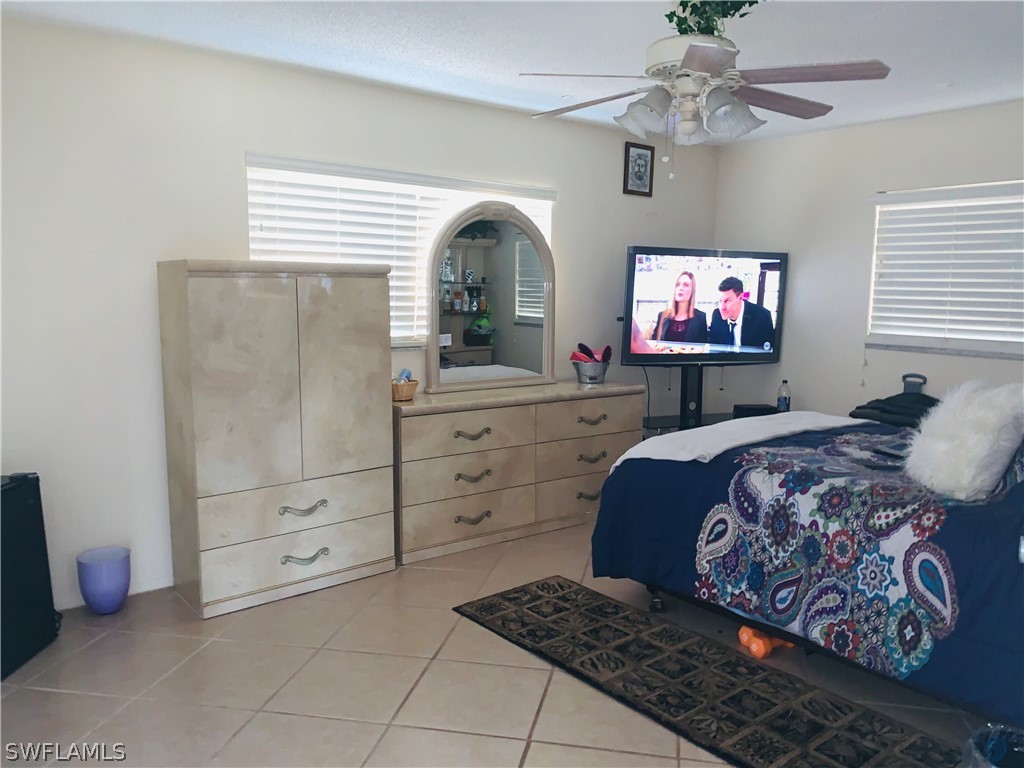 18189 Iris Road Fort Myers, FL 33967 - Photo 10 of 30 a bedroom with a bed and a flat screen tv