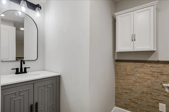 a bathroom with a sink and a mirror