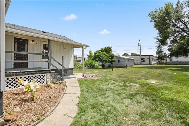 a view of a house with backyard porch and sitting area