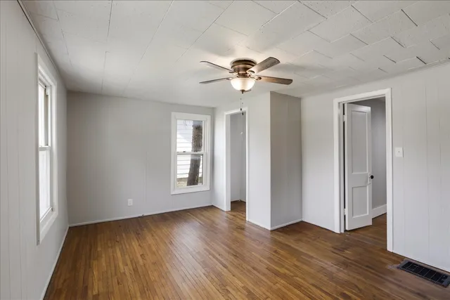 a view of room with hardwood floor and ceiling fan