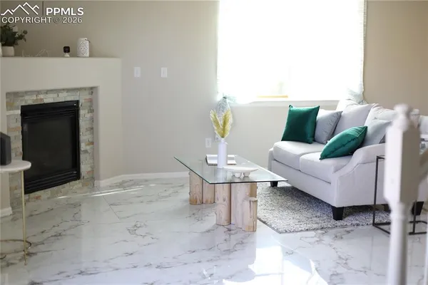 a living room with furniture and a fireplace