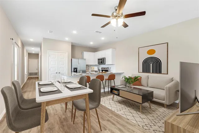a living room with furniture kitchen view and a chandelier