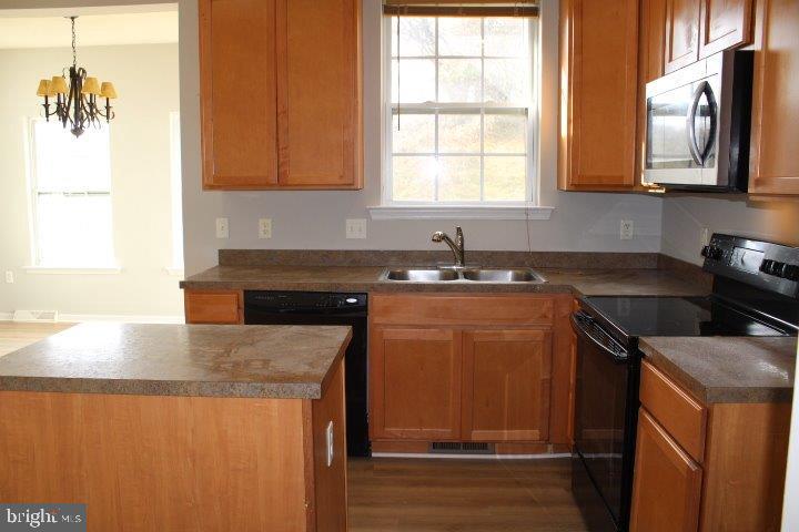 304 Cape Climb York, PA 17408 - Photo 2 of 6 a kitchen with stainless steel appliances granite countertop a sink a stove and a microwave